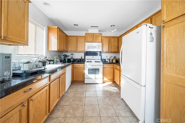 a kitchen with stainless steel appliances granite countertop a refrigerator sink and cabinets