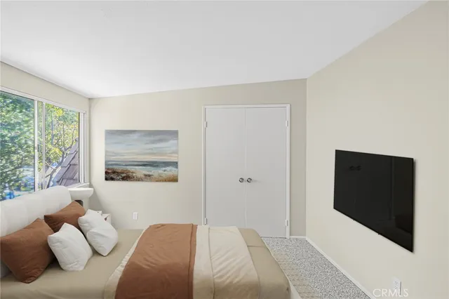 a bedroom with a bed and a television