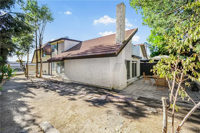 a view of a house with a tree in the background