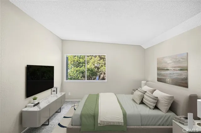 a bedroom with a bed and a flat screen tv