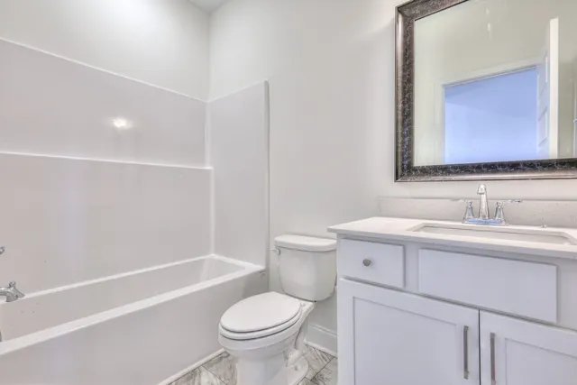 a bathroom with a sink toilet vanity and shower