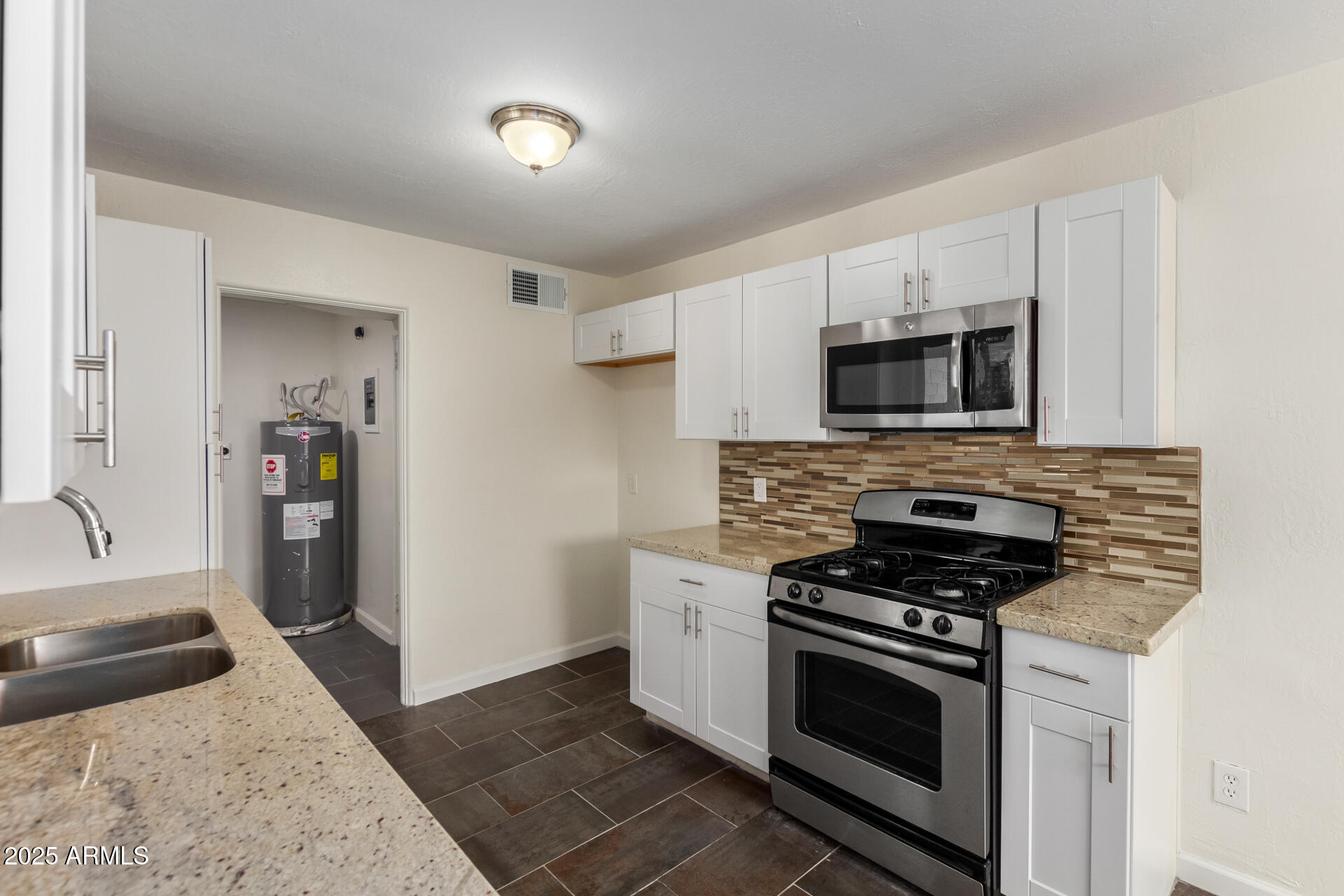 1401 East Osborn Road Phoenix, AZ 85014 - Photo 13 of 36 a kitchen with granite countertop a stove and a sink