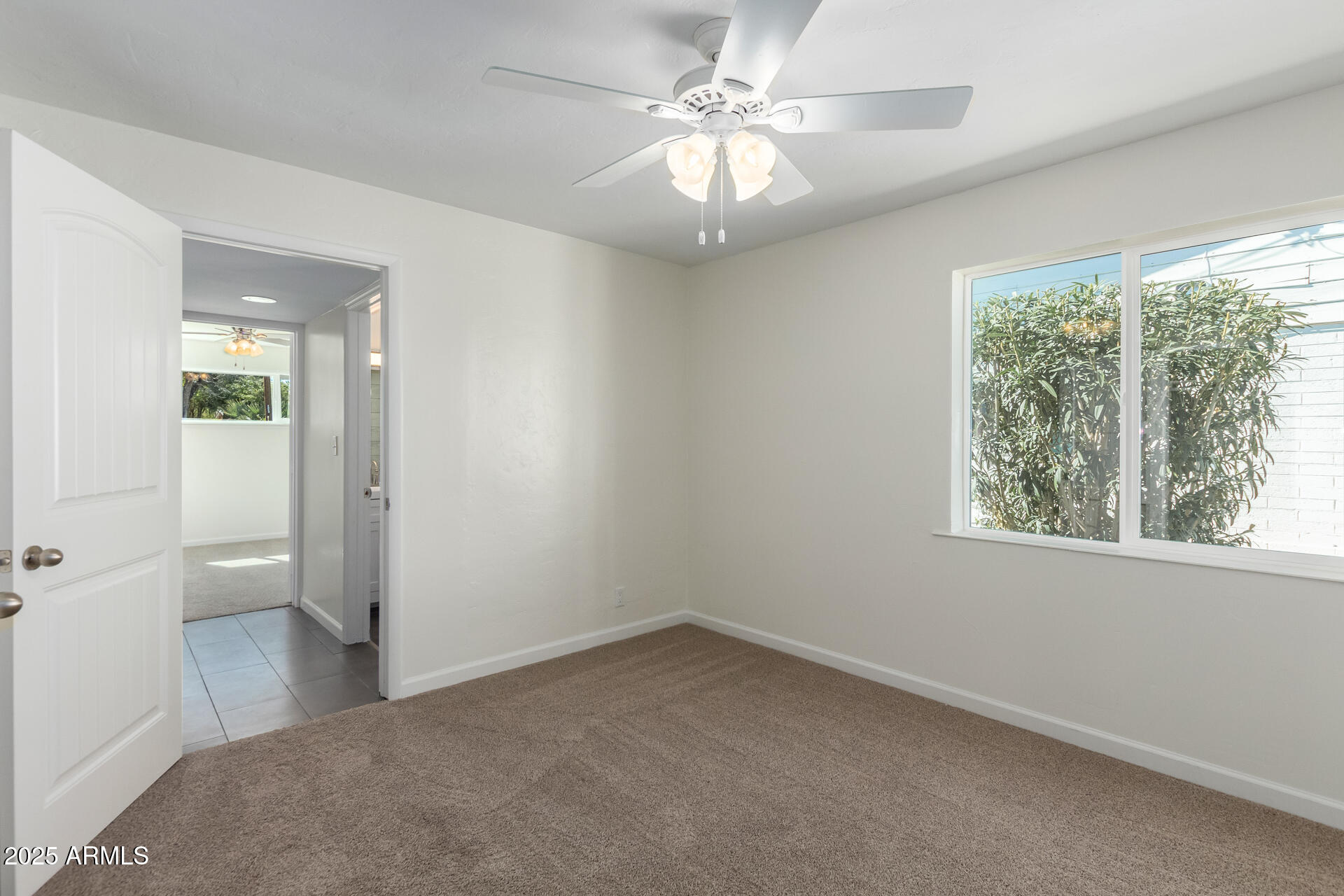 1401 East Osborn Road Phoenix, AZ 85014 - Photo 18 of 36 an empty room and a bathroom with a window