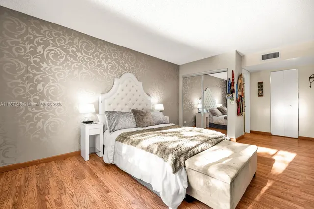 a bedroom with a bed and mirror