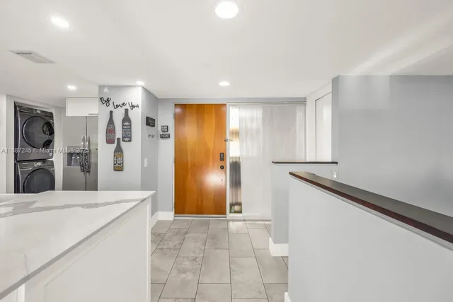a kitchen with stainless steel appliances granite countertop a refrigerator and a stove top oven
