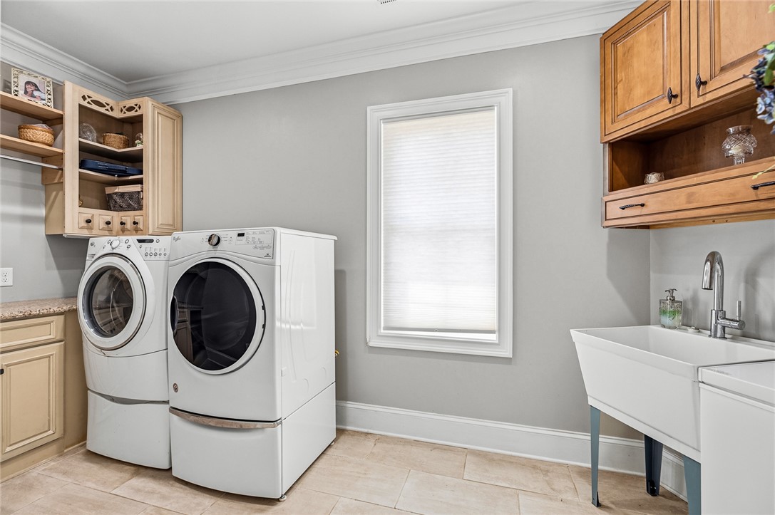 206 James Hare Road Anderson, SC 29626 - Photo 19 of 50 A well-appointed laundry room features ample cabinetry and modern appliances.
