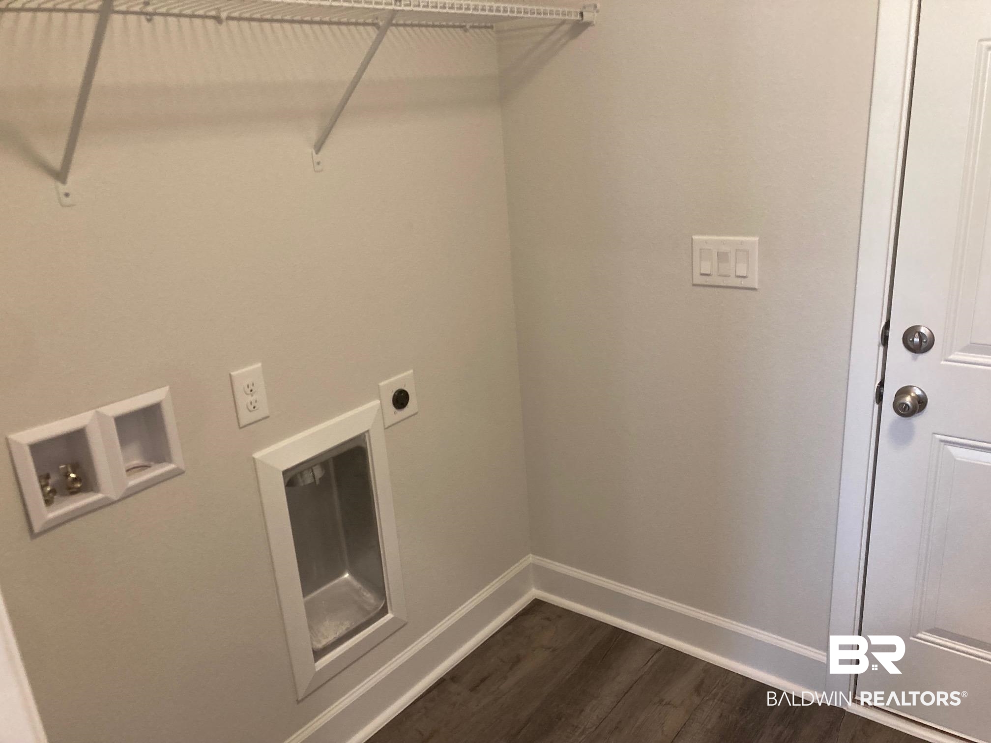 629 Revere Street Foley, AL 36535 - Photo 10 of 30 Washroom with hookup for an electric dryer, hookup for a washing machine, and dark hardwood / wood-style floors