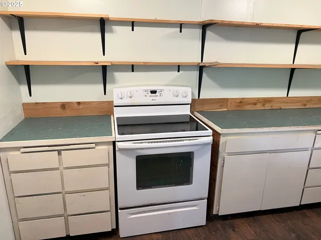 a stove top oven sitting inside of a kitchen