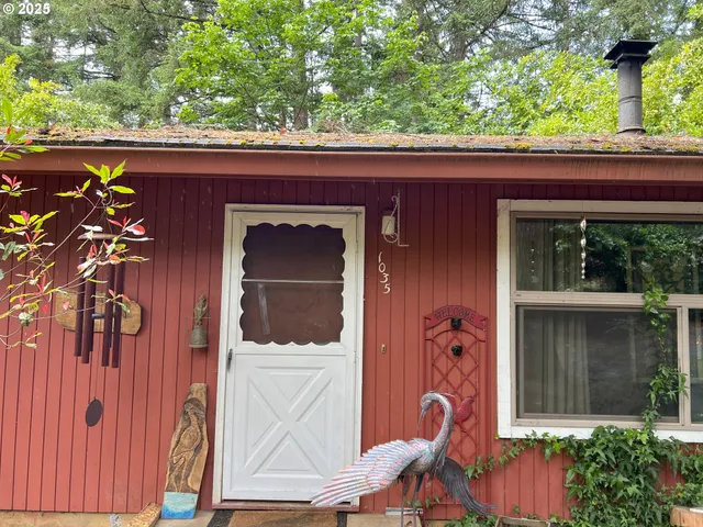a couple of potted plants in front of door
