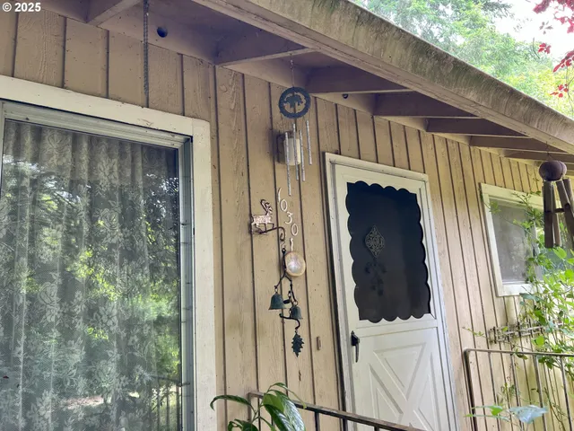 a view of a door and chair in the balcony