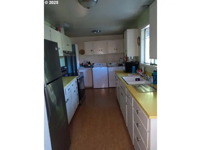 a kitchen with sink a stove and refrigerator