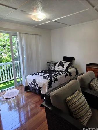 a bed sitting in a bedroom next to a window