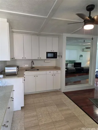a kitchen with a sink cabinets and window