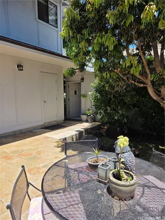 a backyard of a house with table and chairs