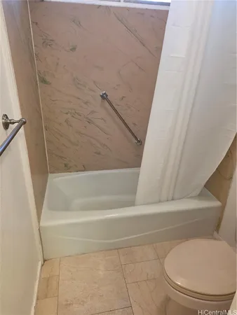 a bathroom with a toilet and bathtub