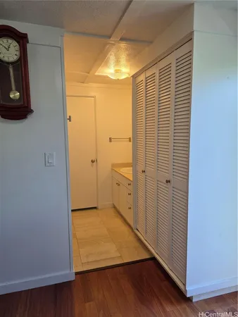 a big room with wooden floor and a bathroom