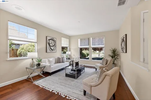 a living room with furniture dining table and a large window