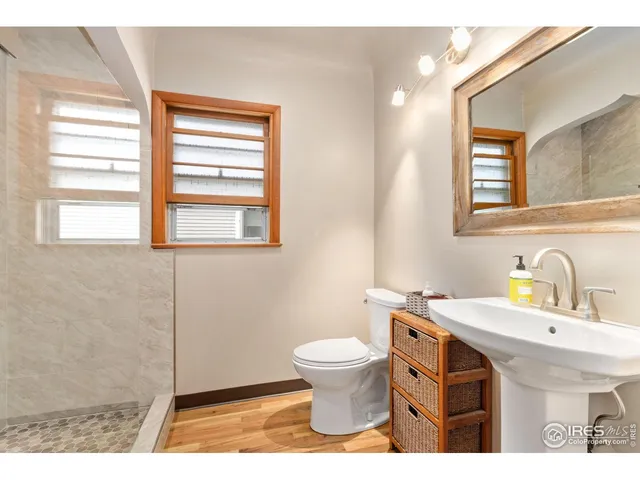 a bathroom with a sink a toilet and a window