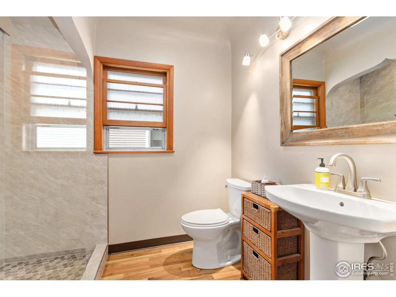 805 Walnut Street Windsor, CO 80550 - Photo 13 of 33 Updated bathroom with pedestal sink and large shower with concrete / tile pan