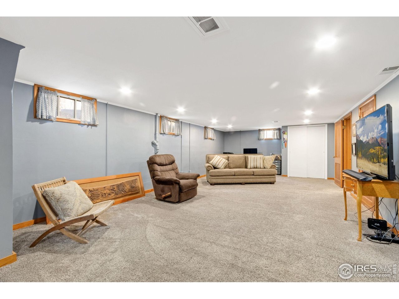 805 Walnut Street Windsor, CO 80550 - Photo 17 of 36 a living room with furniture and a flat screen tv
