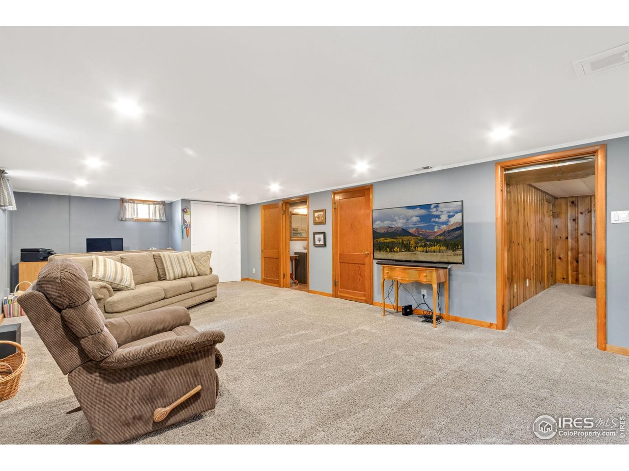 805 Walnut Street Windsor, CO 80550 - Photo 18 of 36 a living room with furniture and a flat screen tv