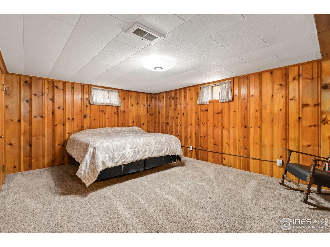 805 Walnut Street Windsor, CO 80550 - Photo 20 of 36 a bedroom with a large bed and a window