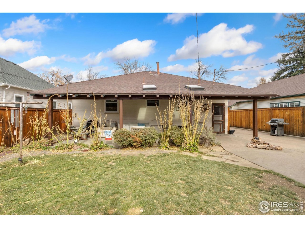 805 Walnut Street Windsor, CO 80550 - Photo 24 of 36 a view of a house with backyard outdoor seating area and barbeque oven