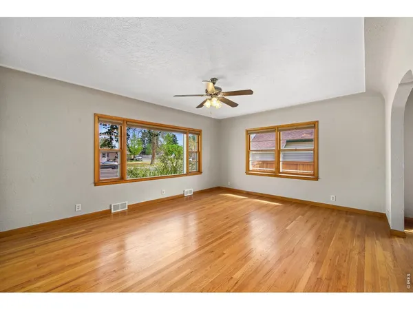 wooden floor in an empty room with a window
