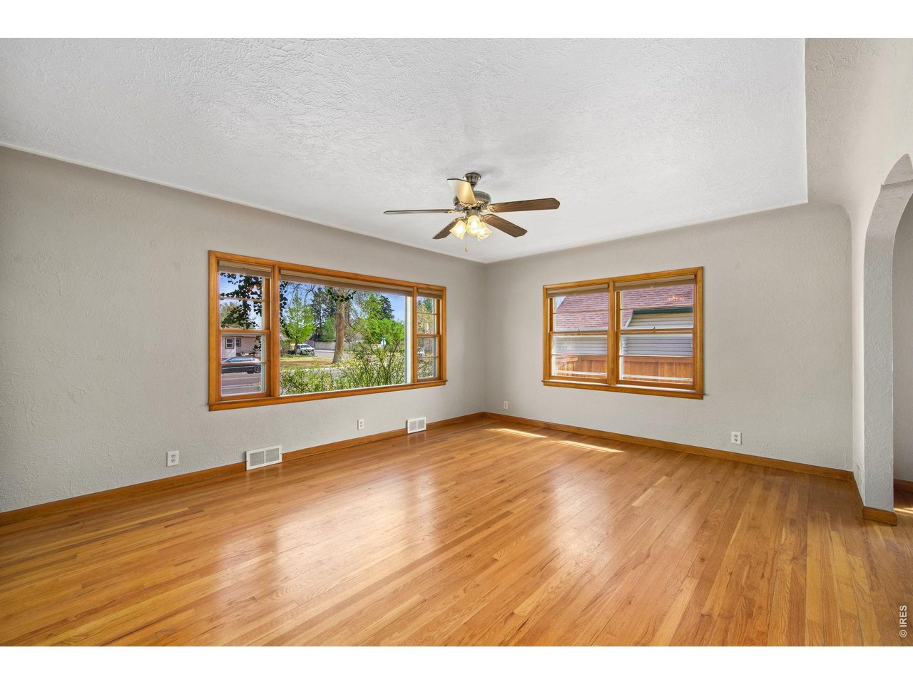 805 Walnut Street Windsor, CO 80550 - Photo 4 of 36 wooden floor in an empty room with a window