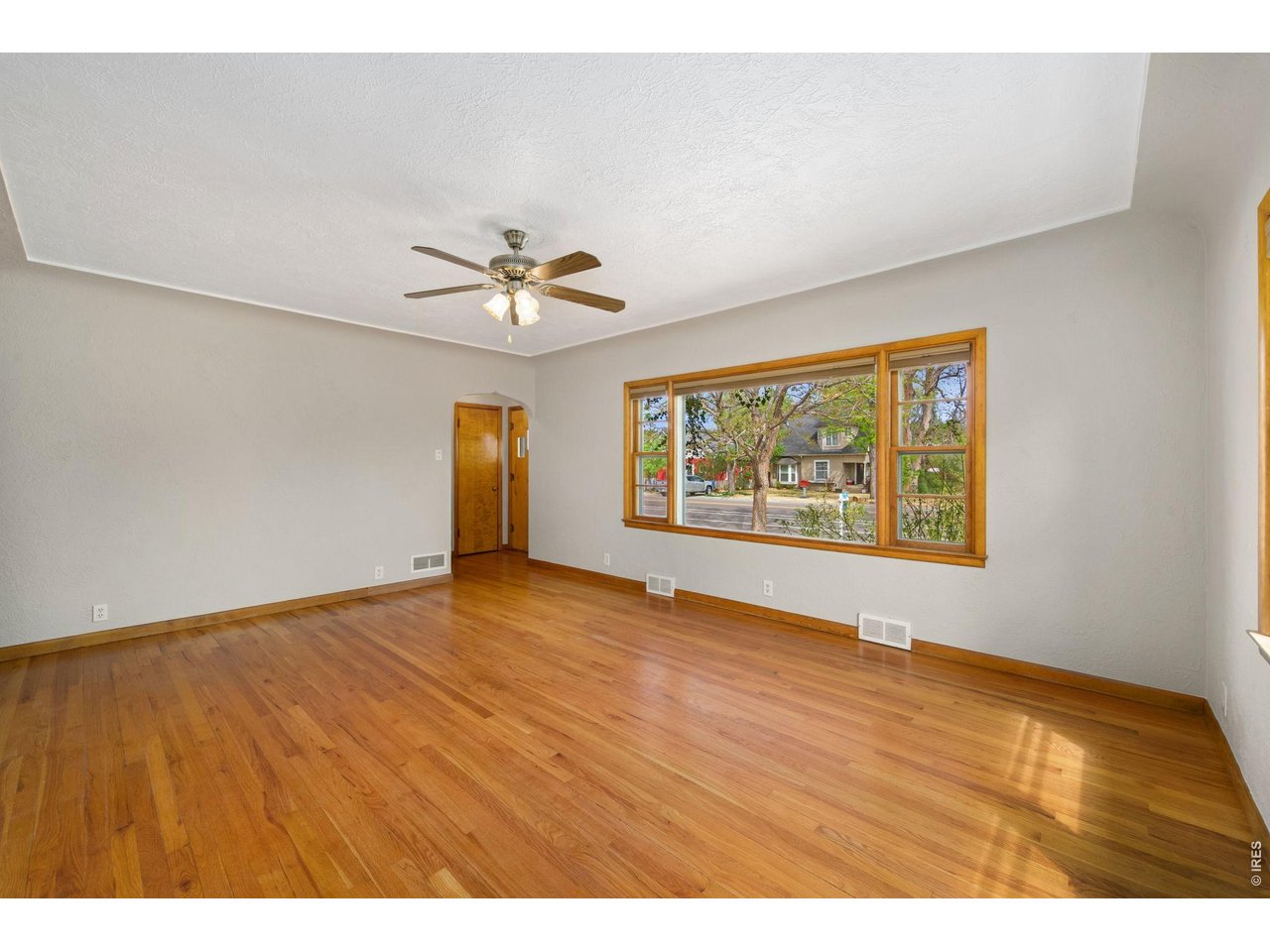 805 Walnut Street Windsor, CO 80550 - Photo 5 of 36 a view of an empty room with a window
