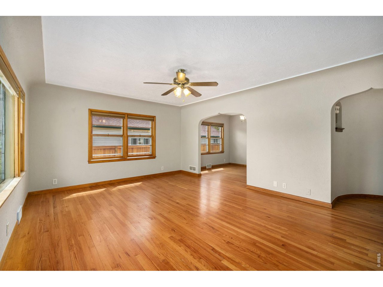 805 Walnut Street Windsor, CO 80550 - Photo 7 of 36 a view of an empty room with window and wooden floor