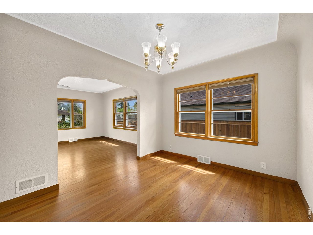 805 Walnut Street Windsor, CO 80550 - Photo 8 of 36 a view of an empty room with a window and wooden floor