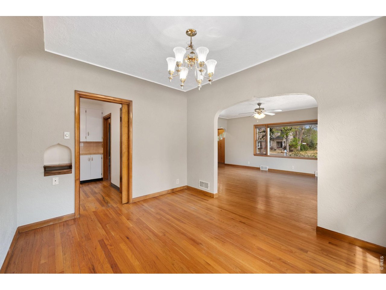 805 Walnut Street Windsor, CO 80550 - Photo 9 of 36 a view of an empty room with window and wooden floor