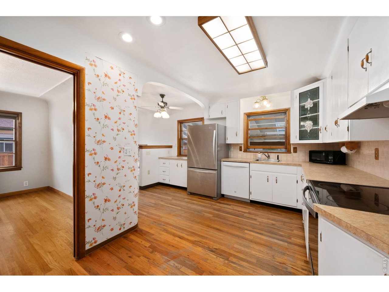 805 Walnut Street Windsor, CO 80550 - Photo 10 of 36 a kitchen with stainless steel appliances a refrigerator and a stove top oven