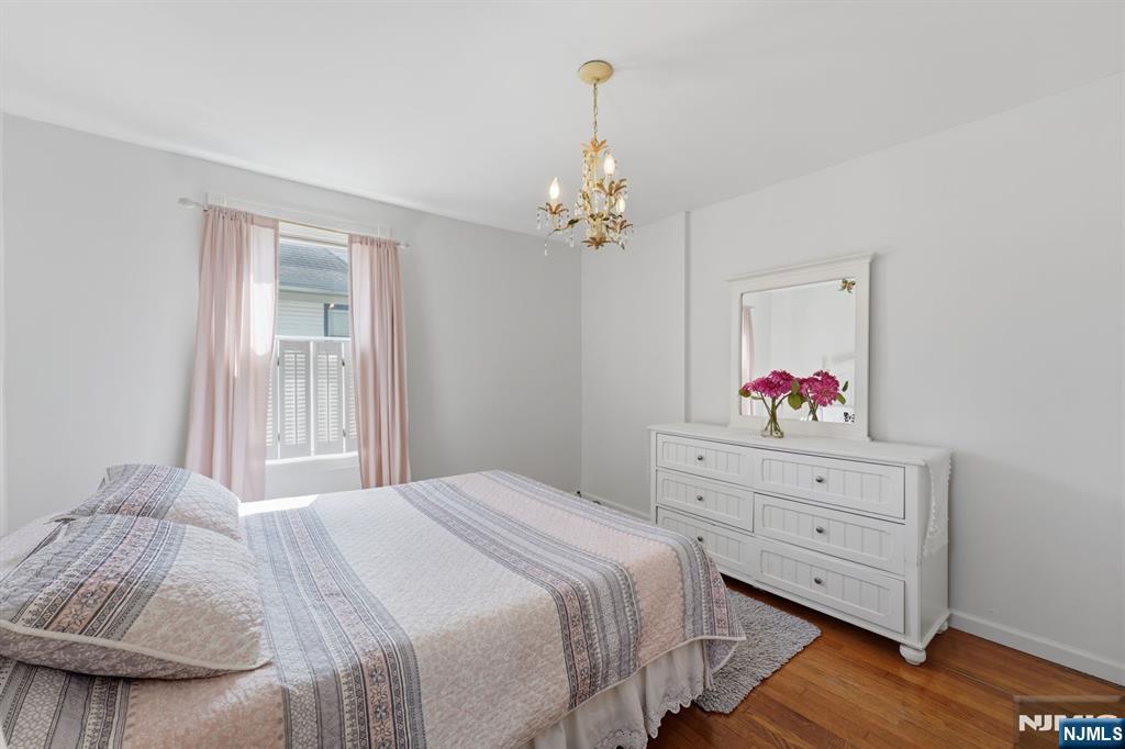385 Berkeley Avenue Bloomfield, NJ 07003 - Photo 14 of 39 a bedroom with a bed and a dresser
