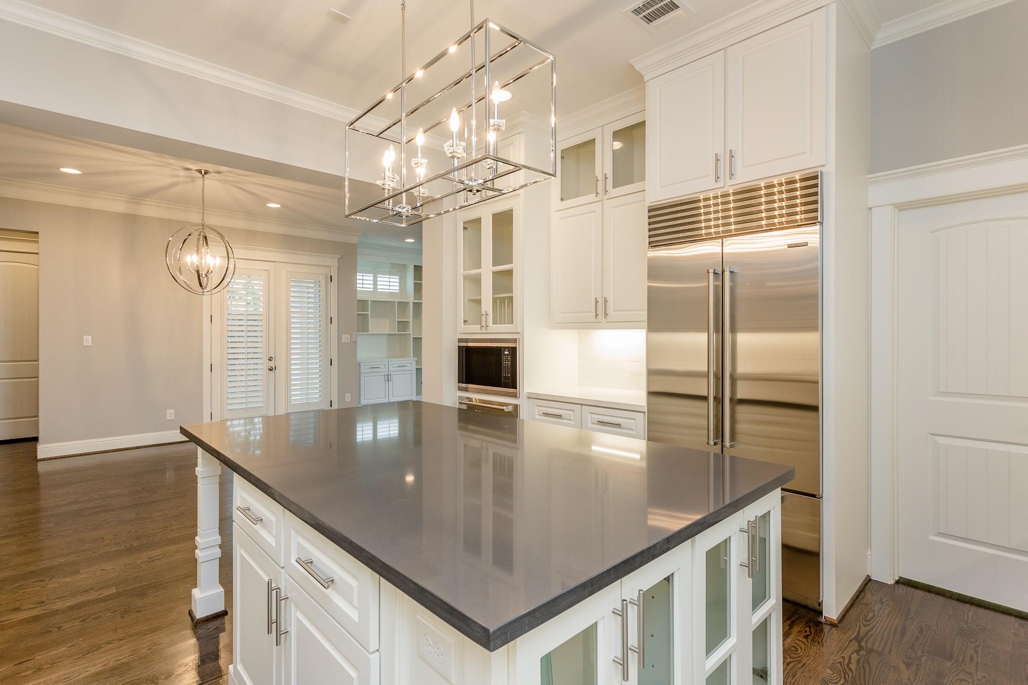 2035 Sheridan Street, Unit A Houston, TX 77030 - Photo 12 of 41 a kitchen with stainless steel appliances granite countertop a sink refrigerator and cabinets