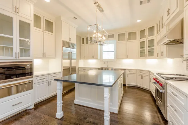 a kitchen with a sink stove and cabinets
