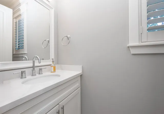 a spacious bathroom with a double vanity sink mirror and shower
