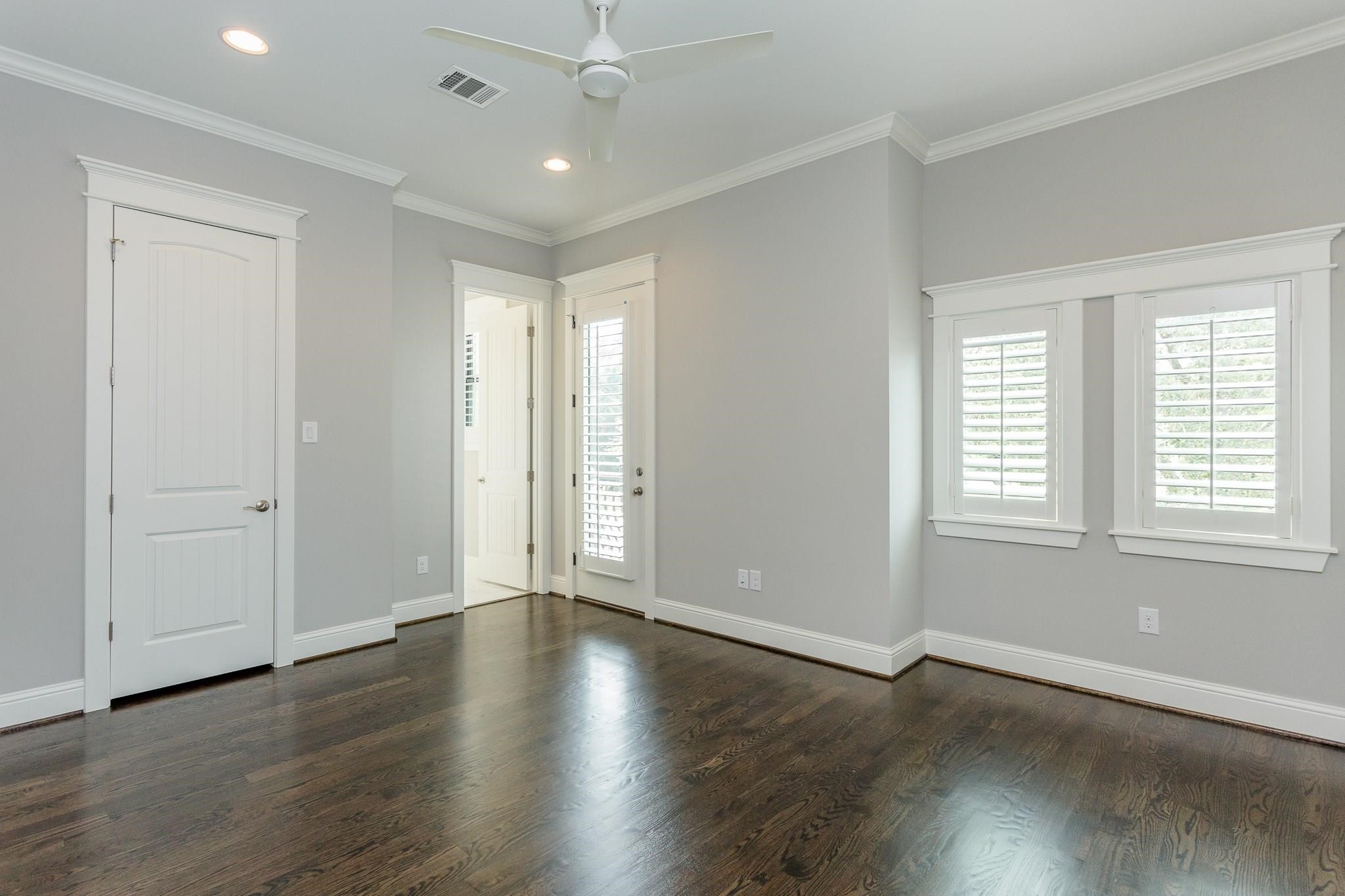 2035 Sheridan Street, Unit A Houston, TX 77030 - Photo 19 of 41 an empty room with wooden floor and windows