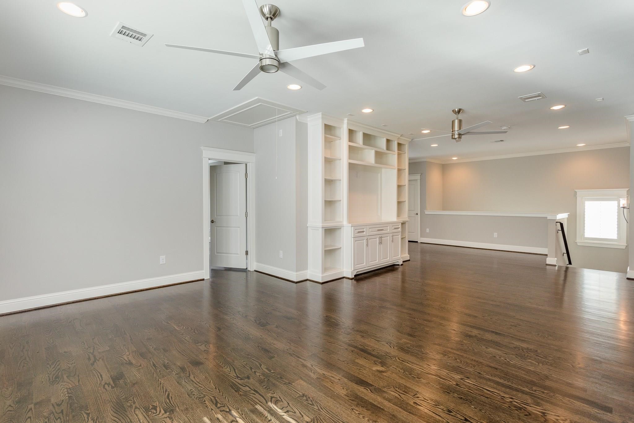 2035 Sheridan Street, Unit A Houston, TX 77030 - Photo 24 of 41 an empty room with wooden floor and windows