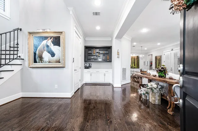 a living room with furniture potted plant and a chandelier