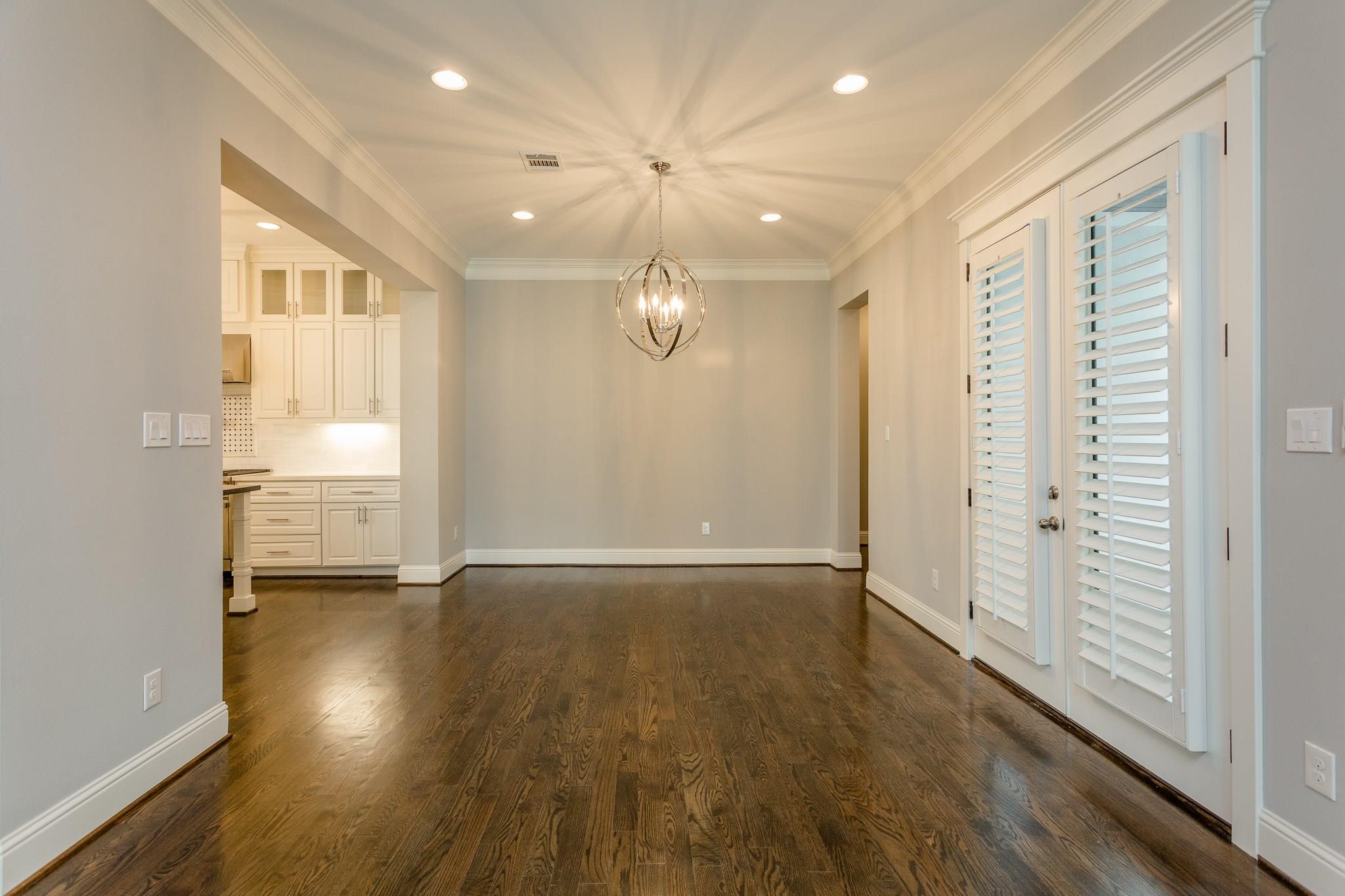 2035 Sheridan Street, Unit A Houston, TX 77030 - Photo 7 of 41 an empty room with wooden floor and windows