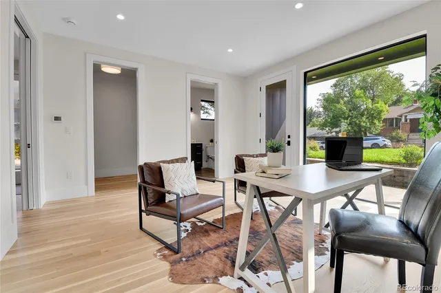 a view of a workspace with furniture and a window