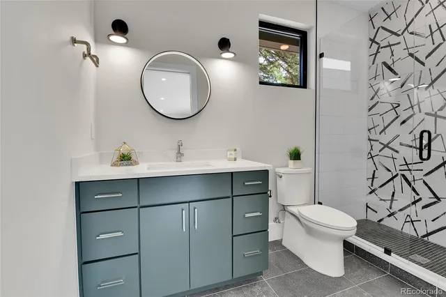a bathroom with a toilet a sink and mirror