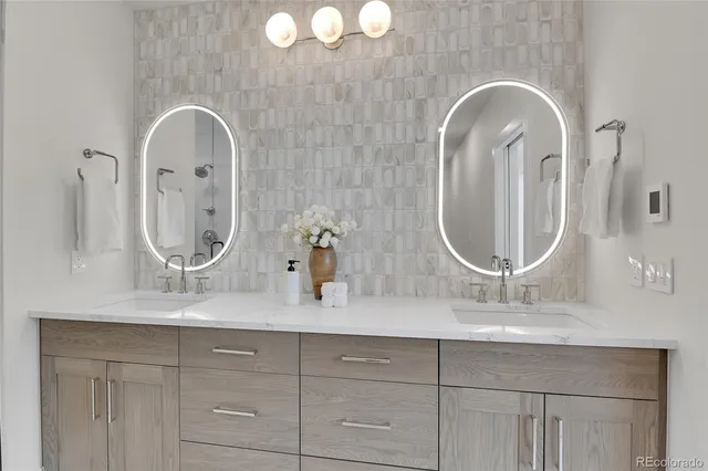 a bathroom with a double vanity sink mirror and