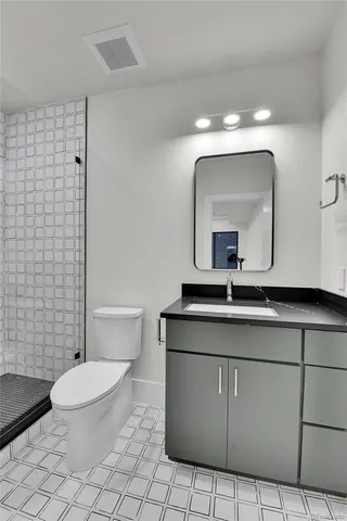 an empty room with windows and cabinet