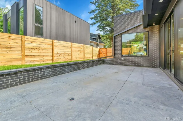 a view of balcony with wooden floor and fence