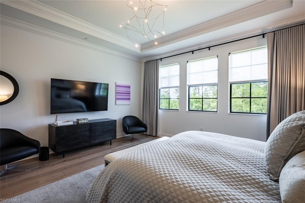 16360 Viansa Way, Unit 8201 Naples, FL 34110 - Photo 13 of 35 a bedroom with bed tv and window