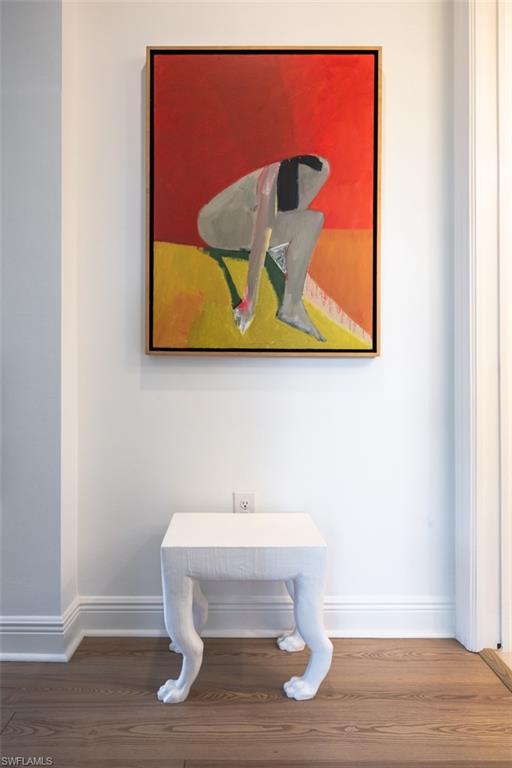 16360 Viansa Way, Unit 8201 Naples, FL 34110 - Photo 18 of 35 a room with a wooden wall painting and a lamp