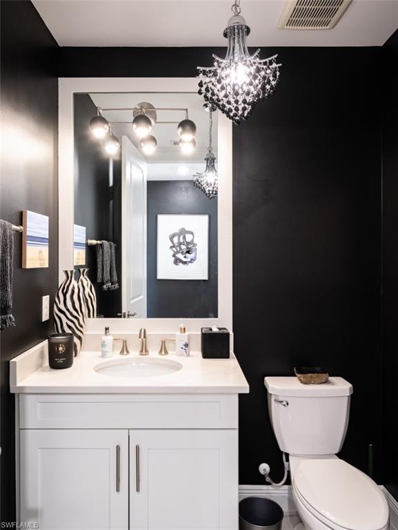 16360 Viansa Way, Unit 8201 Naples, FL 34110 - Photo 20 of 35 a bathroom with a toilet sink and mirror